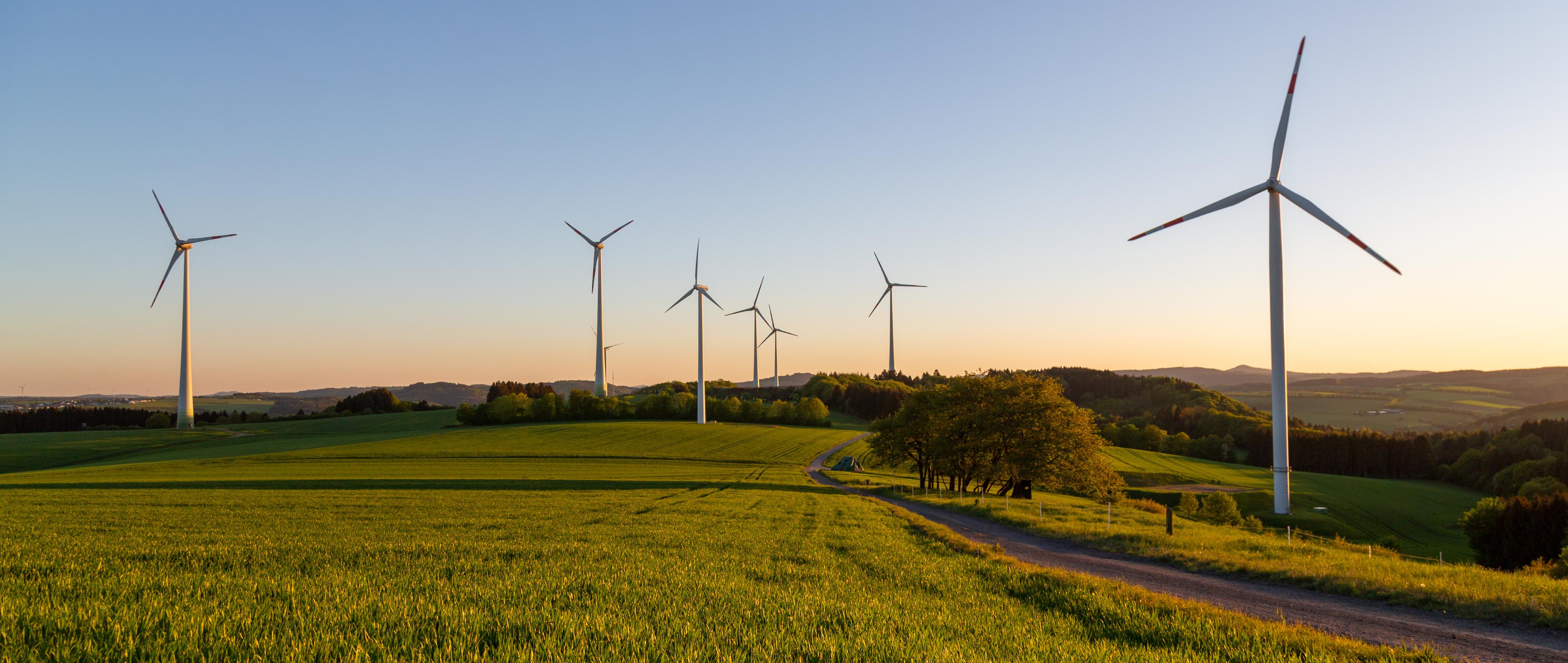 Windmills standing in an open field